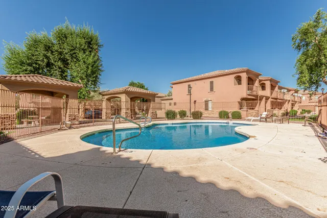a view of house with swimming pool outdoor seating