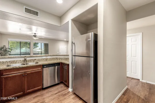 a kitchen with stainless steel appliances wooden cabinets and a stove top oven
