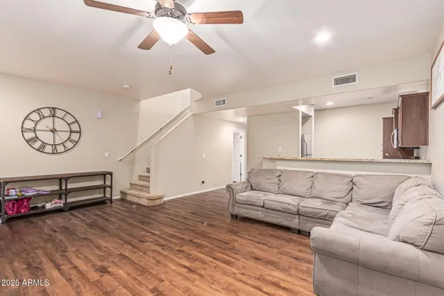 a living room with furniture a bed and a chandelier