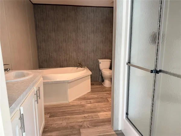 a white toilet sitting next to a bathroom sink
