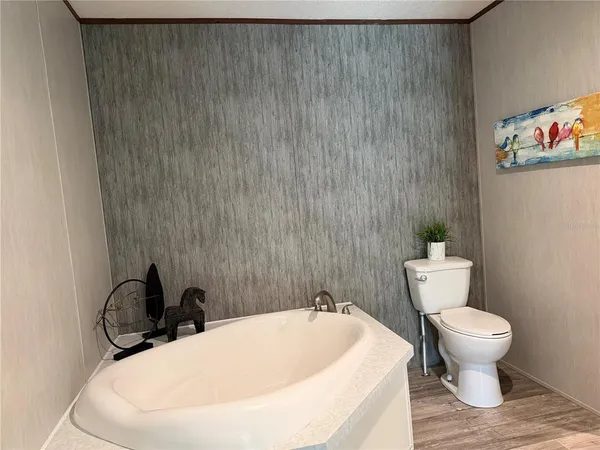 a white toilet sitting next to a bathroom sink