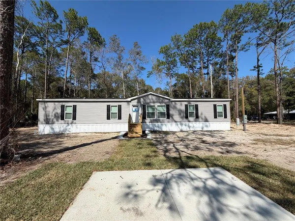 a view of house with a yard