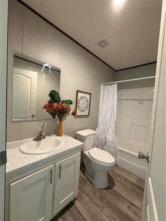 a bathroom with a double vanity sink mirror and toilet