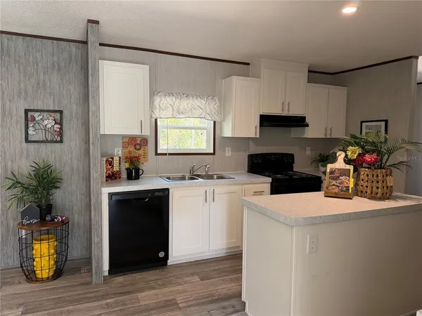 a kitchen with a sink and a stove top oven