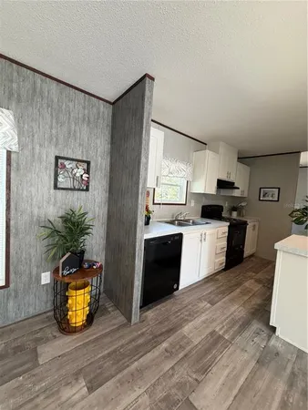 a kitchen with a refrigerator and a sink