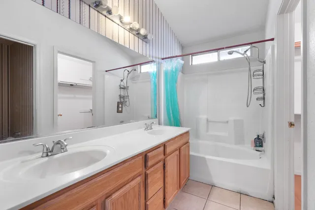 a bathroom with a tub sink and mirror