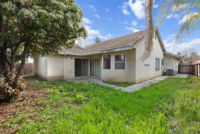 a view of backyard of house with green space
