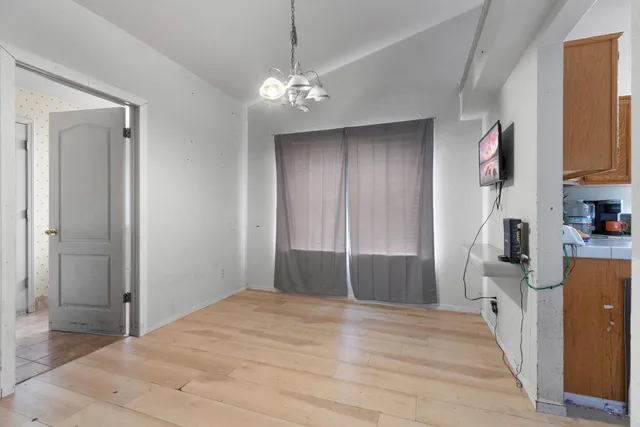 a bedroom with a bed and a chandelier