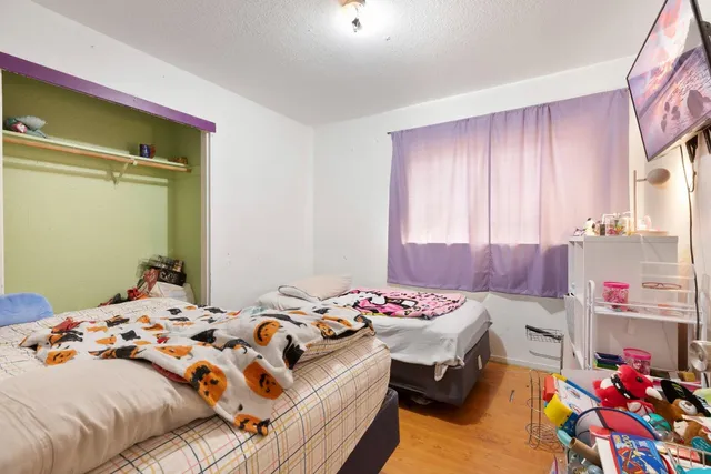 a bedroom with a bed and a dresser