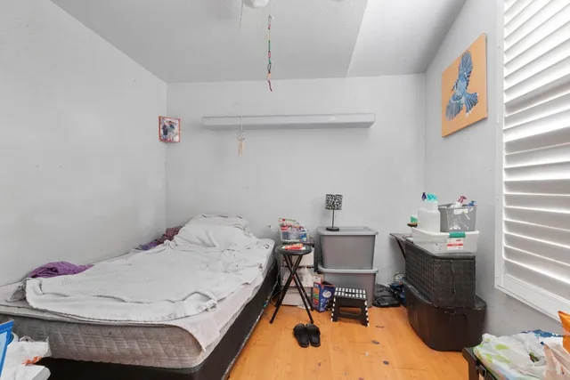 a bedroom with a bed and a window