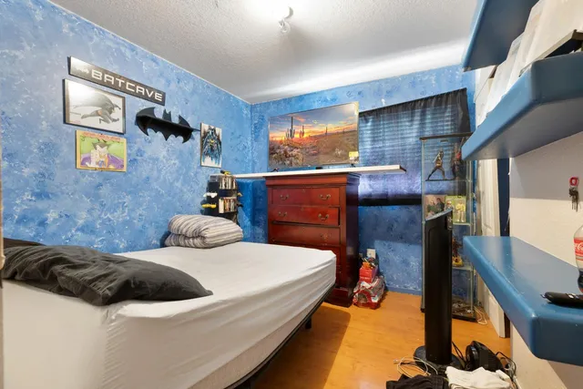 a bedroom with a bed and a dresser