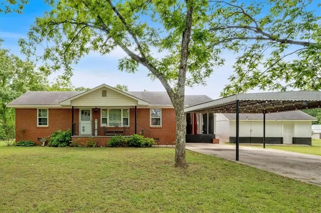 a front view of a house with a garden