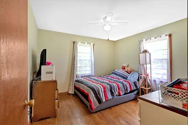 a bedroom with a bed and a window