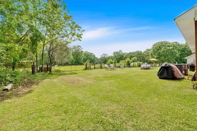 a view of outdoor space with deck and yard