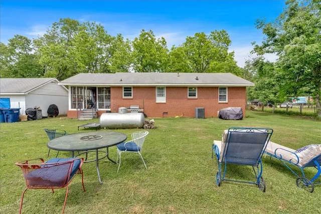 a view of a chair and table in the backyard of the house