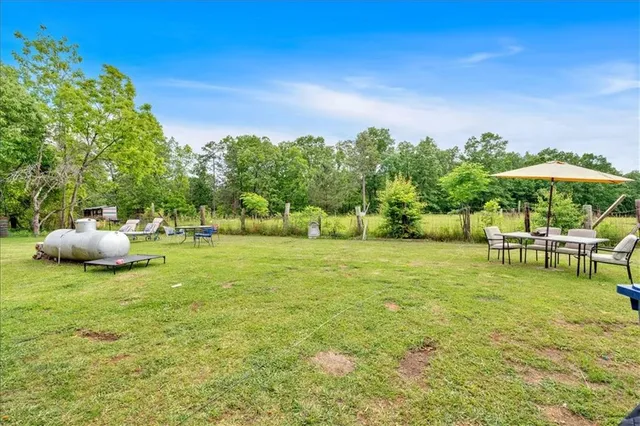 a backyard of a house with table and chairs
