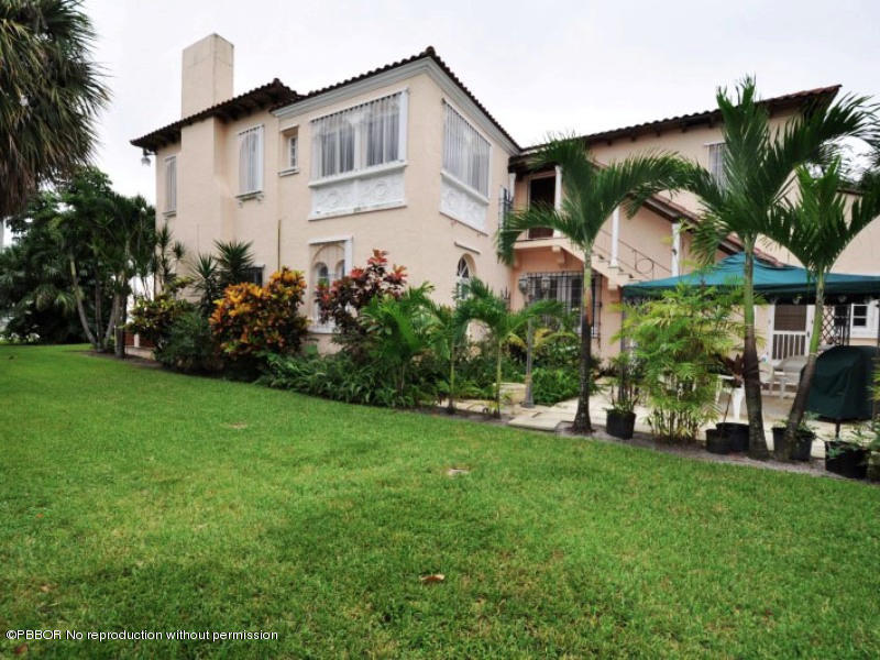 245 Valencia Road West Palm Beach, FL 33401 - Photo 1 of 19 a front view of a house with garden