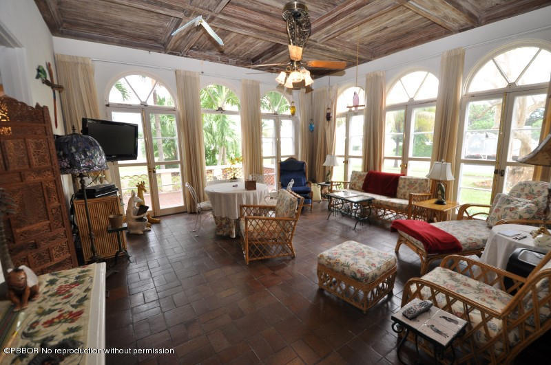 245 Valencia Road West Palm Beach, FL 33401 - Photo 11 of 19 a living room with furniture a chandelier and a large window