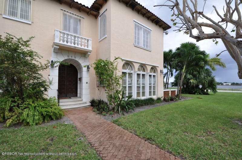 245 Valencia Road West Palm Beach, FL 33401 - Photo 3 of 19 a front view of a house with garden