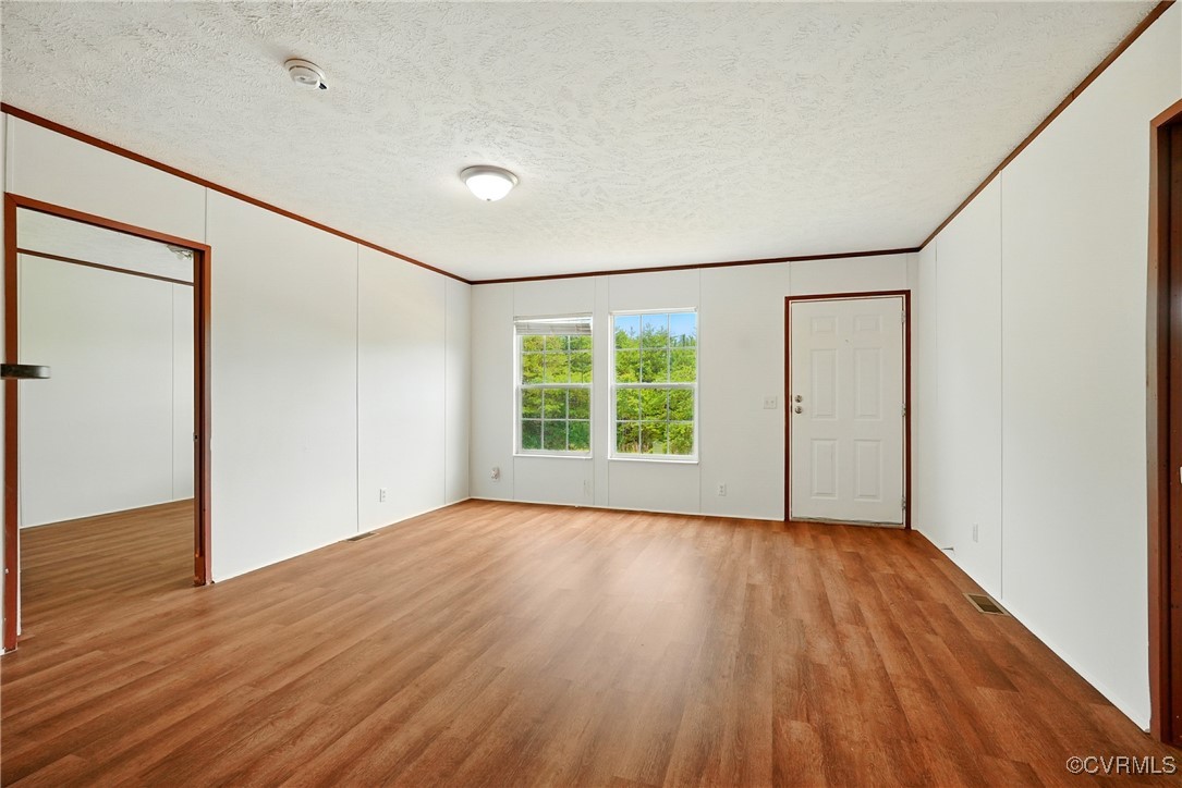 141 Sheppards Drive Farmville, VA 23901 - Photo 7 of 31 a view of an empty room with wooden floor and a window