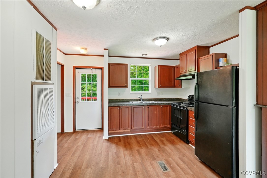 141 Sheppards Drive Farmville, VA 23901 - Photo 8 of 31 a kitchen with stainless steel appliances a refrigerator and wooden floor