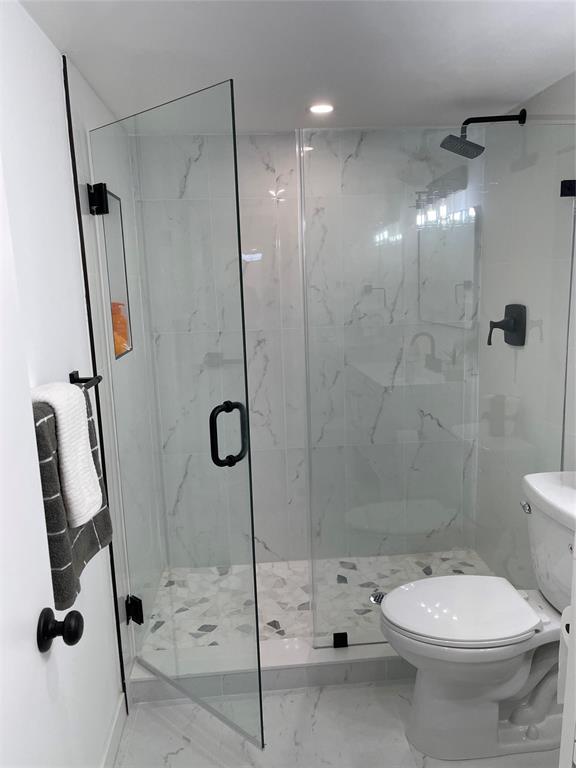 2300 Northeast 1st Lane, Unit 201 Boynton Beach, FL 33435 - Photo 14 of 34 a bathroom with a toilet and a shower