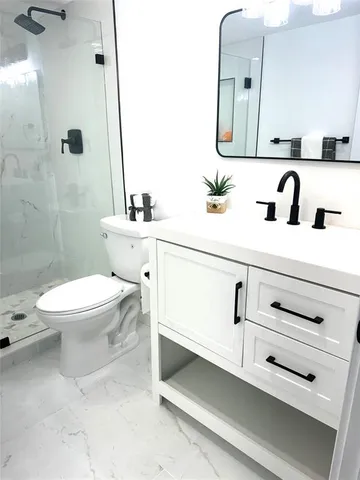 a bathroom with a sink a toilet and mirror