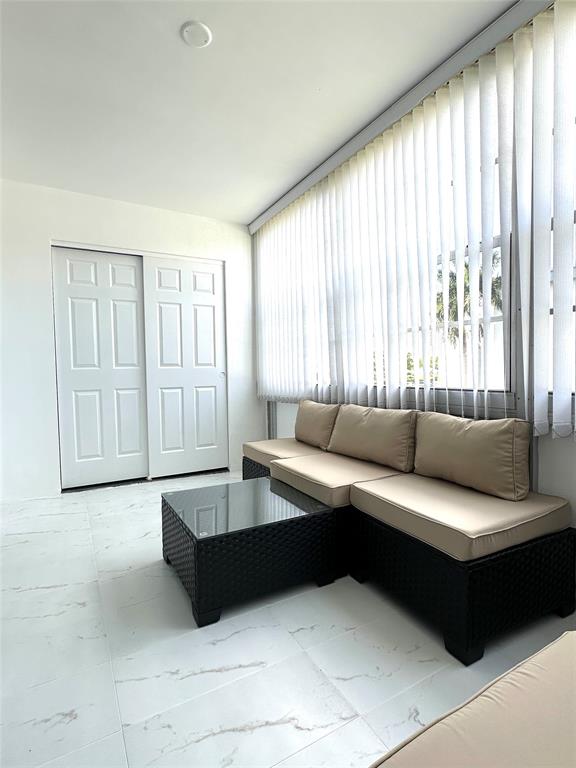 2300 Northeast 1st Lane, Unit 201 Boynton Beach, FL 33435 - Photo 17 of 34 a living room with furniture and a large window