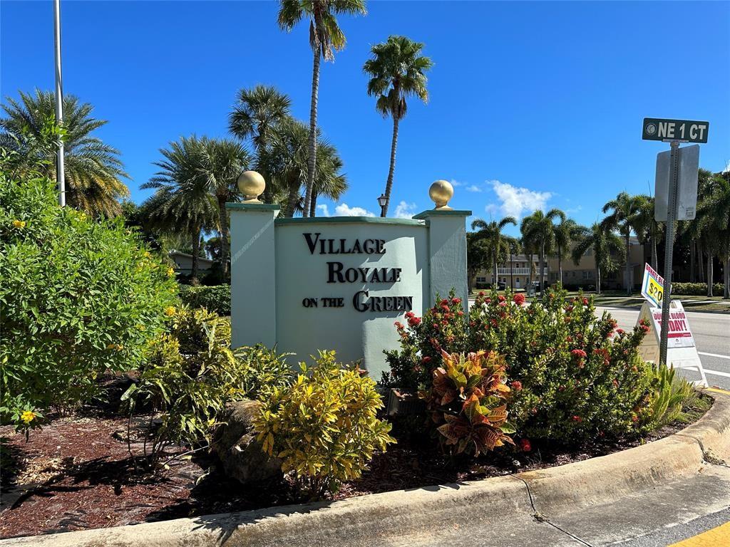 2300 Northeast 1st Lane, Unit 201 Boynton Beach, FL 33435 - Photo 23 of 34 a sign that is sitting in front of flowers