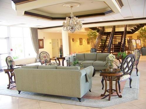 2300 Northeast 1st Lane, Unit 201 Boynton Beach, FL 33435 - Photo 34 of 34 a living room with fireplace furniture and a chandelier