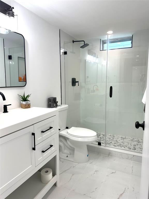 2300 Northeast 1st Lane, Unit 201 Boynton Beach, FL 33435 - Photo 7 of 34 a bathroom with a toilet sink and shower
