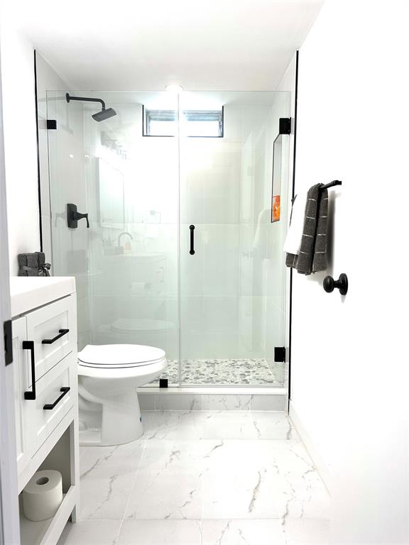 2300 Northeast 1st Lane, Unit 201 Boynton Beach, FL 33435 - Photo 8 of 34 a bathroom with a toilet sink and shower