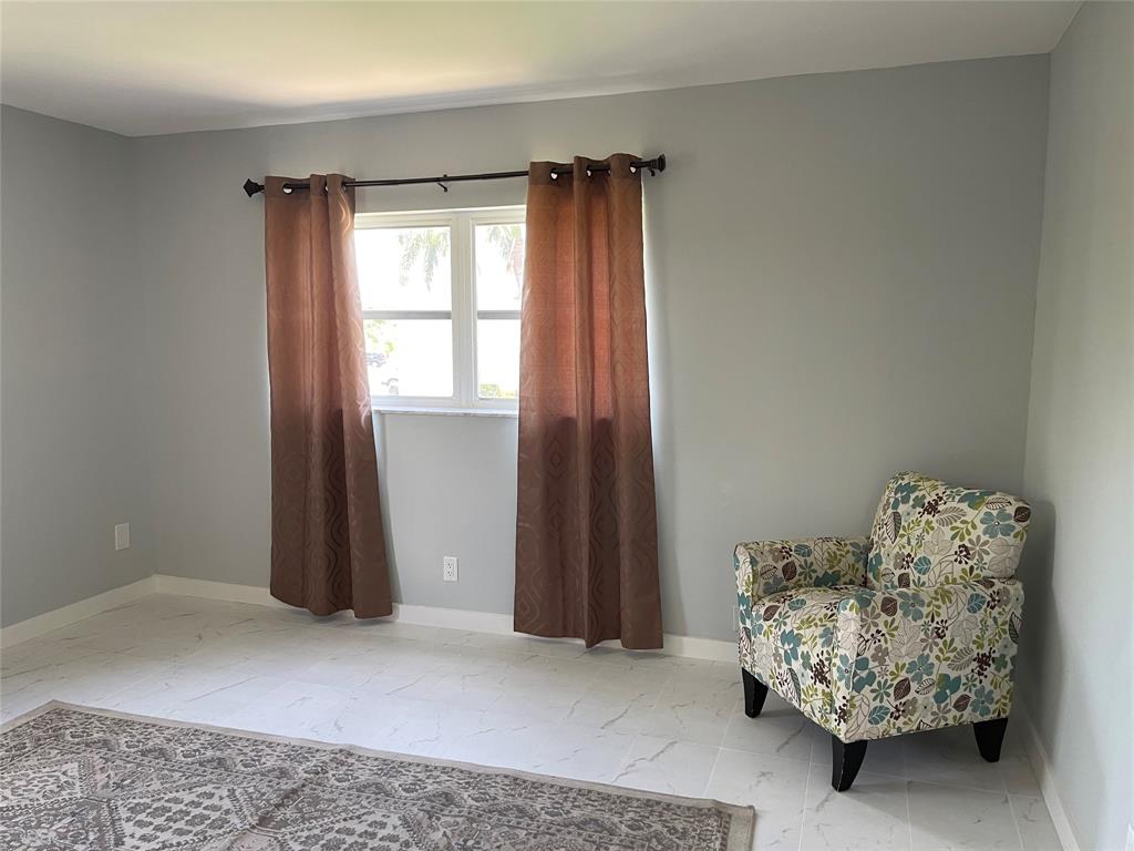 2300 Northeast 1st Lane, Unit 201 Boynton Beach, FL 33435 - Photo 10 of 34 a living room with furniture and a window