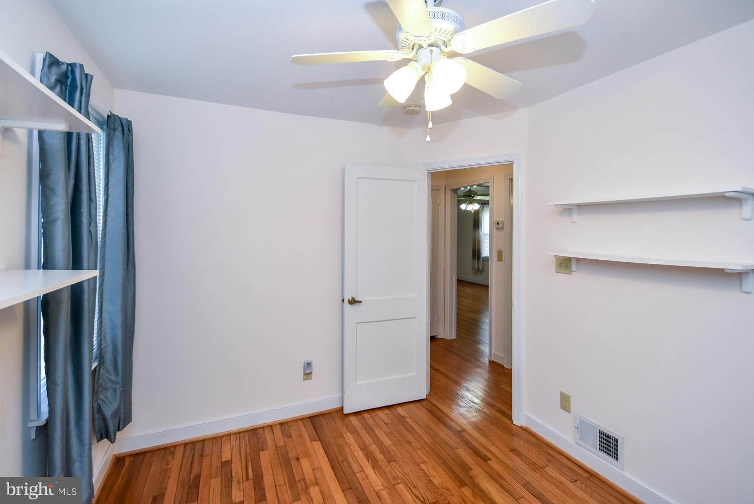 12311 Judson Road Silver Spring, MD 20906 - Photo 14 of 29 wooden floor in an empty room with a window