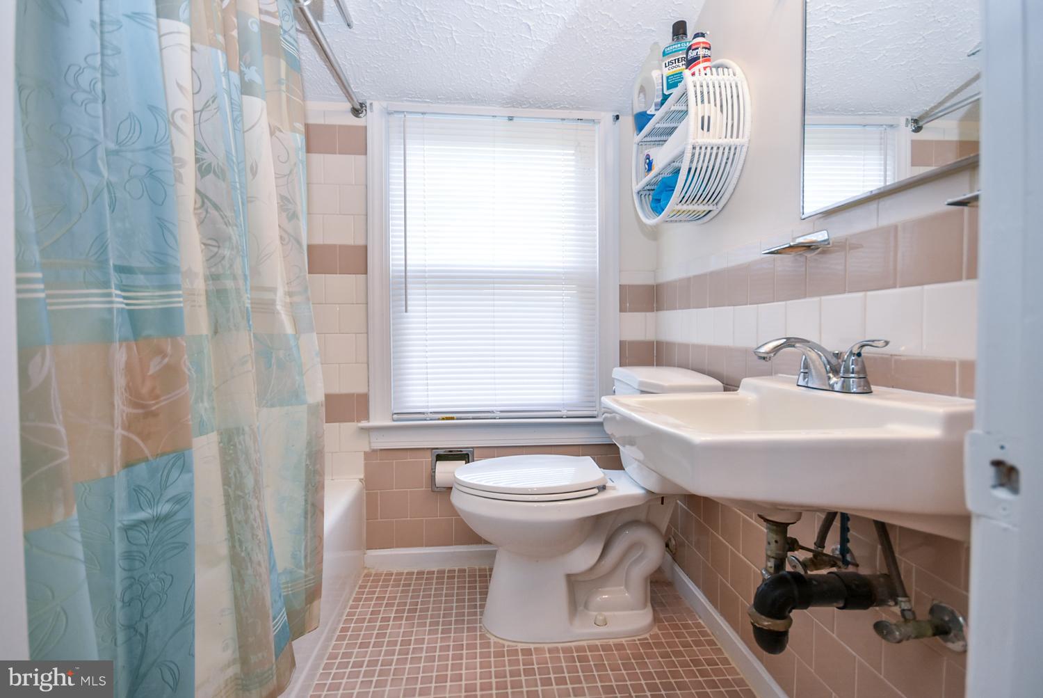 12311 Judson Road Silver Spring, MD 20906 - Photo 20 of 29 a bathroom with a sink a toilet and shower curtain