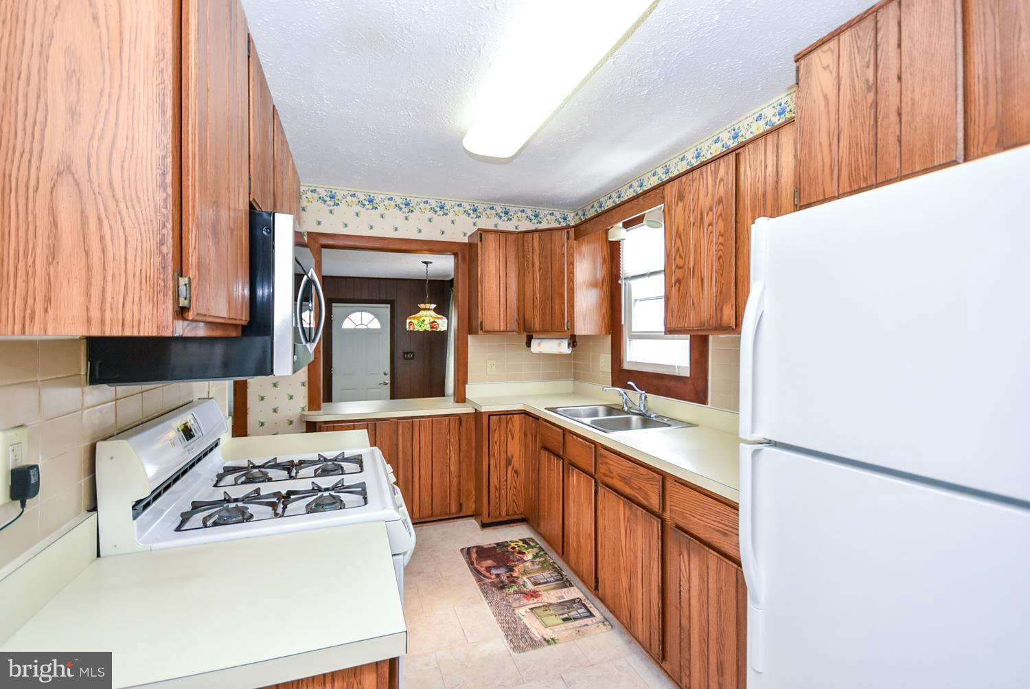 12311 Judson Road Silver Spring, MD 20906 - Photo 5 of 29 a kitchen with a sink and a stove top oven