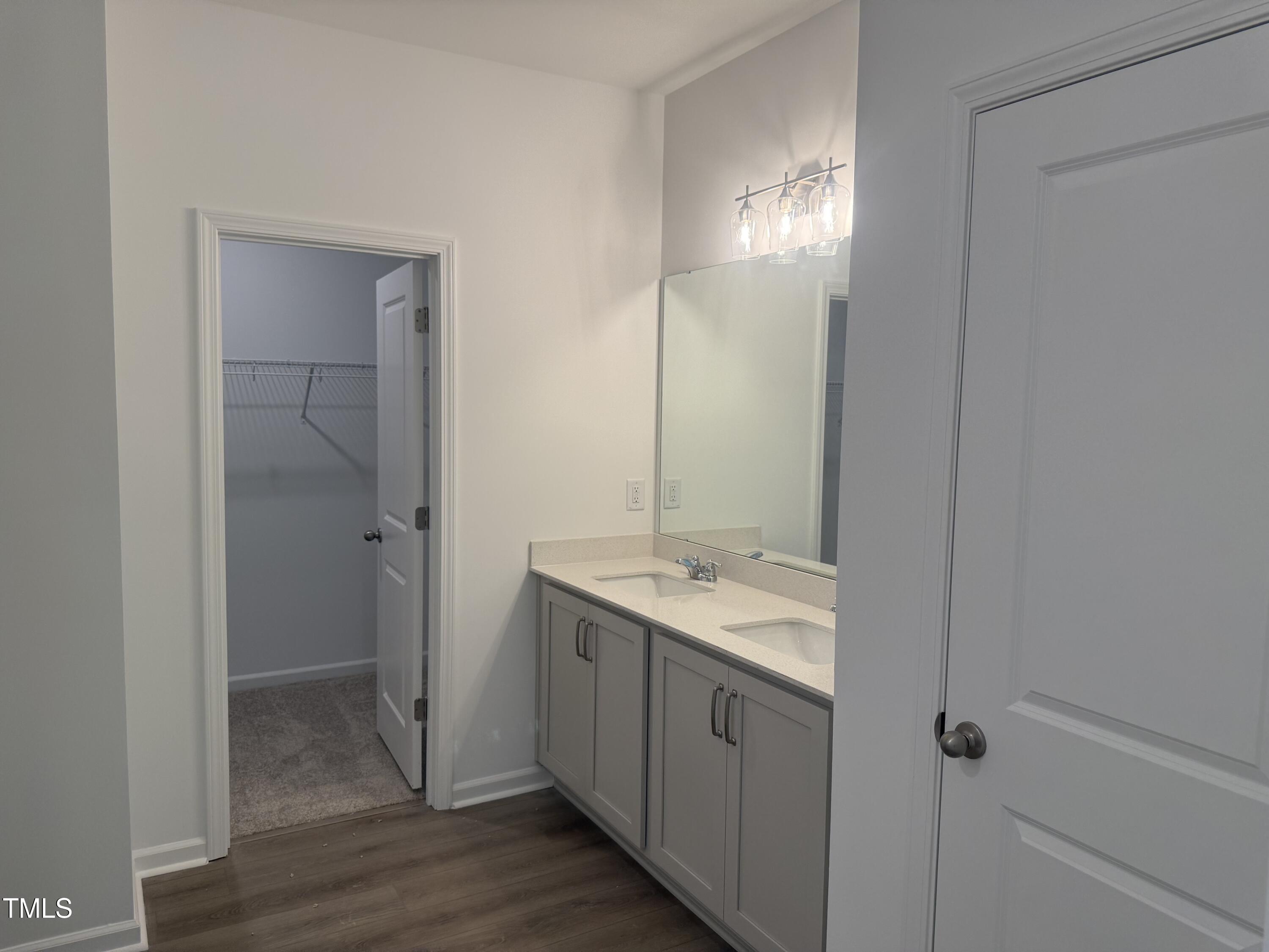 11185 Salers Loop Middlesex, NC 27557 - Photo 11 of 41 a bathroom with a granite countertop sink a mirror and a shower