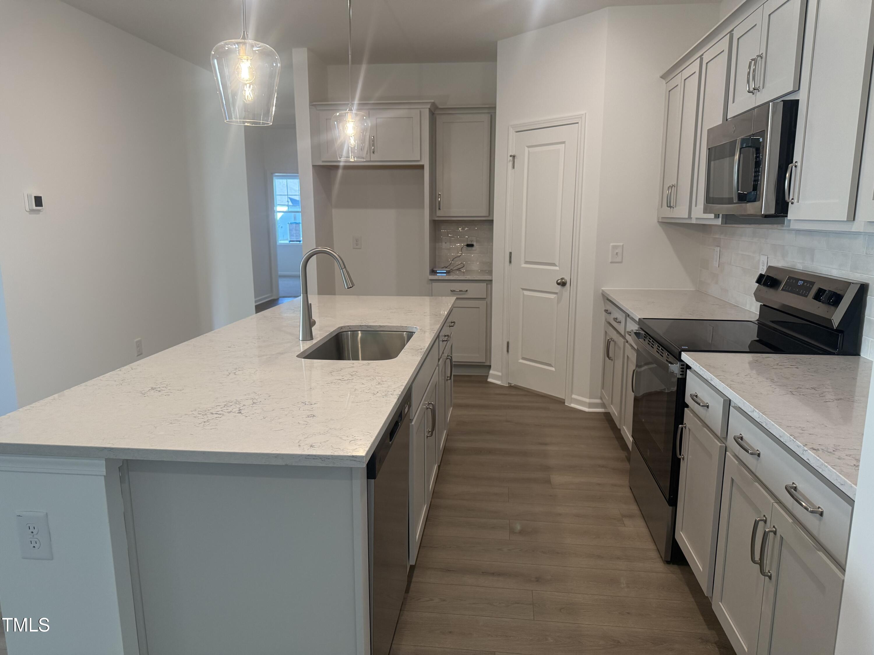 11185 Salers Loop Middlesex, NC 27557 - Photo 2 of 41 a kitchen with a sink and refrigerator
