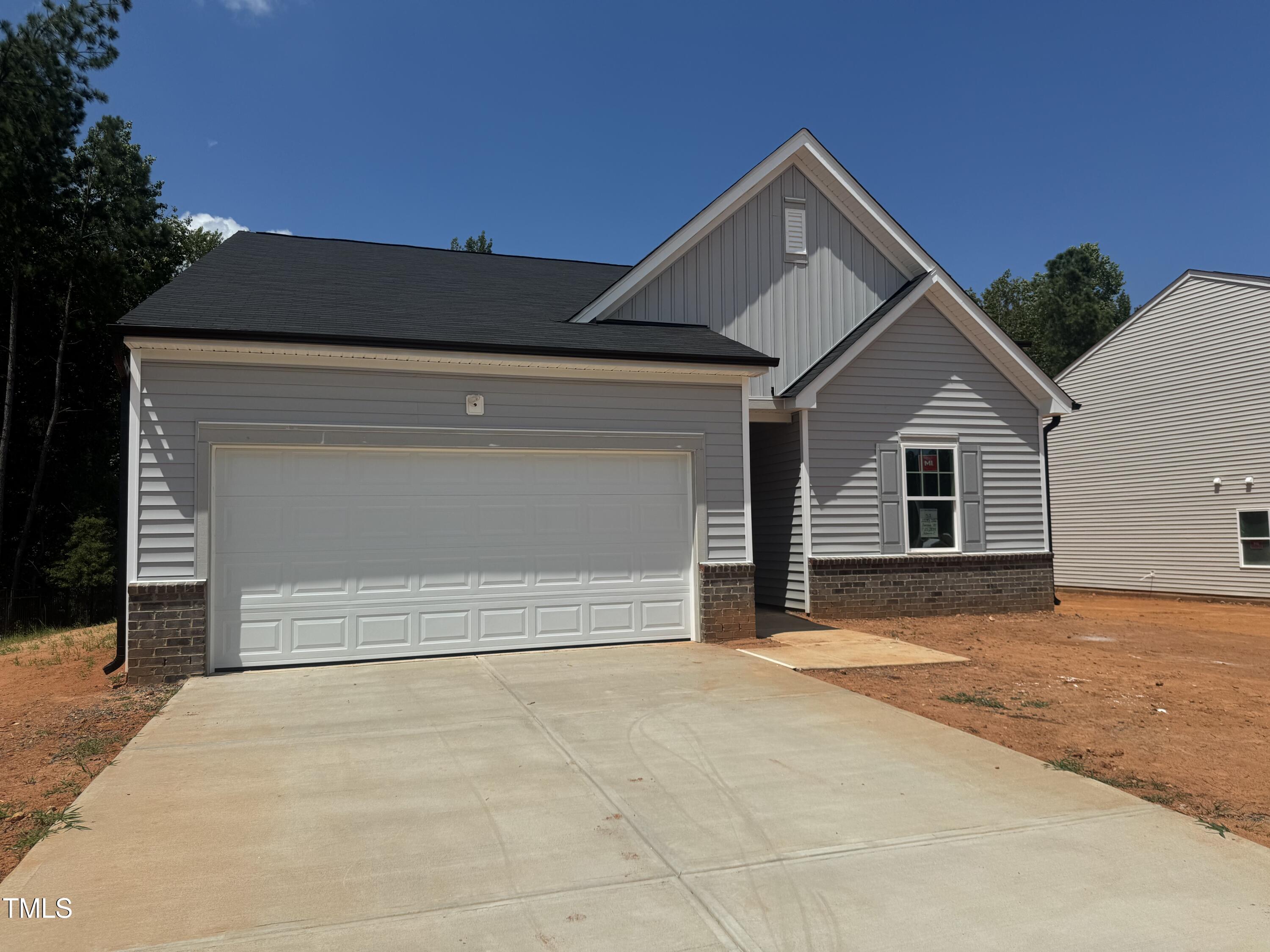 11185 Salers Loop Middlesex, NC 27557 - Photo 24 of 41 a front view of a house with a yard and garage