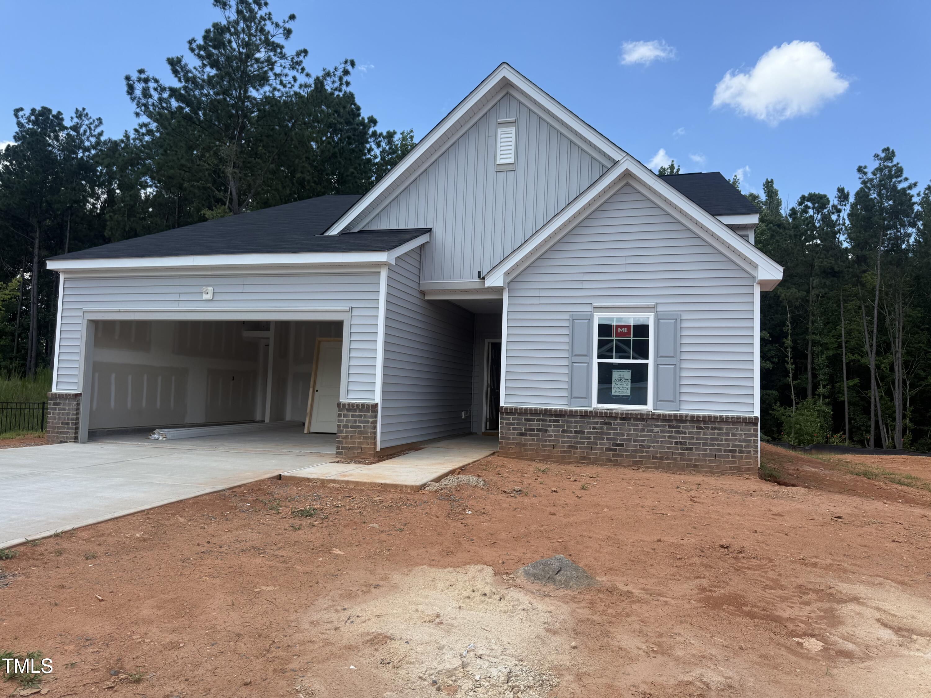 11185 Salers Loop Middlesex, NC 27557 - Photo 26 of 41 a front view of a house with a yard and garage