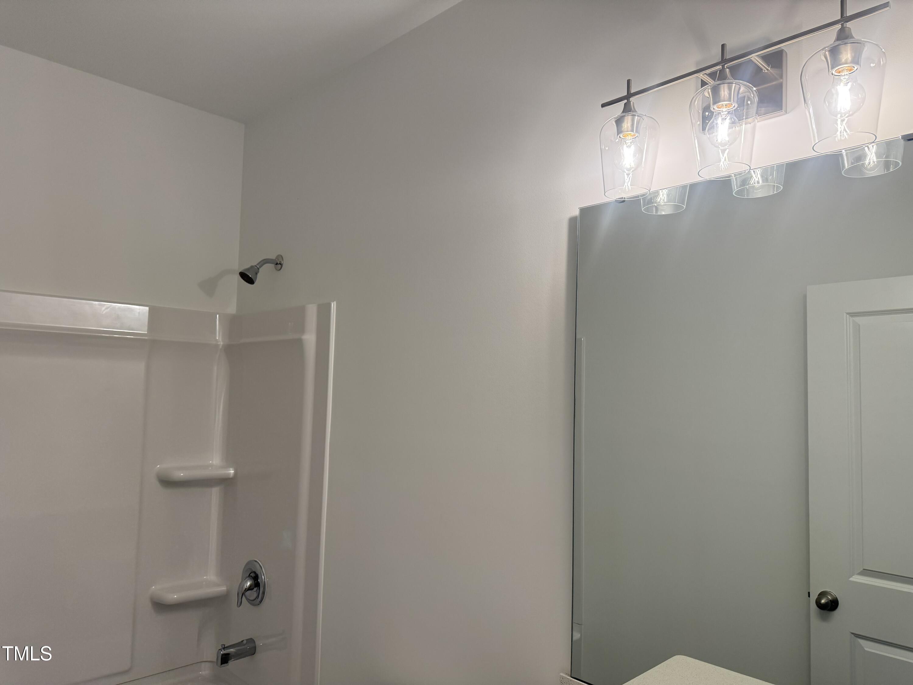 11185 Salers Loop Middlesex, NC 27557 - Photo 32 of 41 a bathroom with a glass shower door