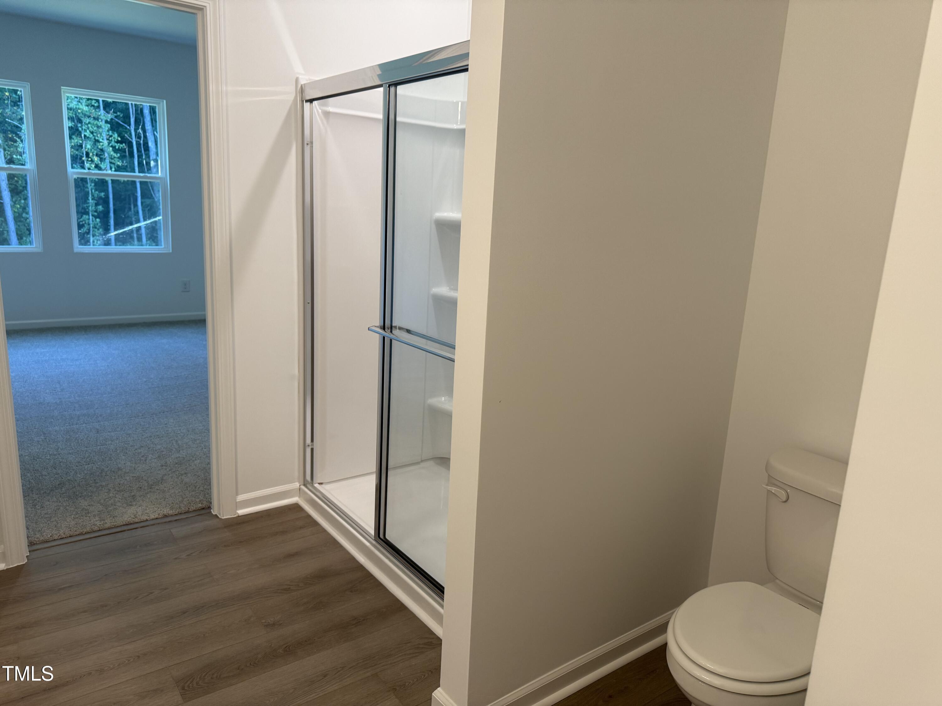 11185 Salers Loop Middlesex, NC 27557 - Photo 40 of 41 a bathroom with a granite countertop toilet and a shower