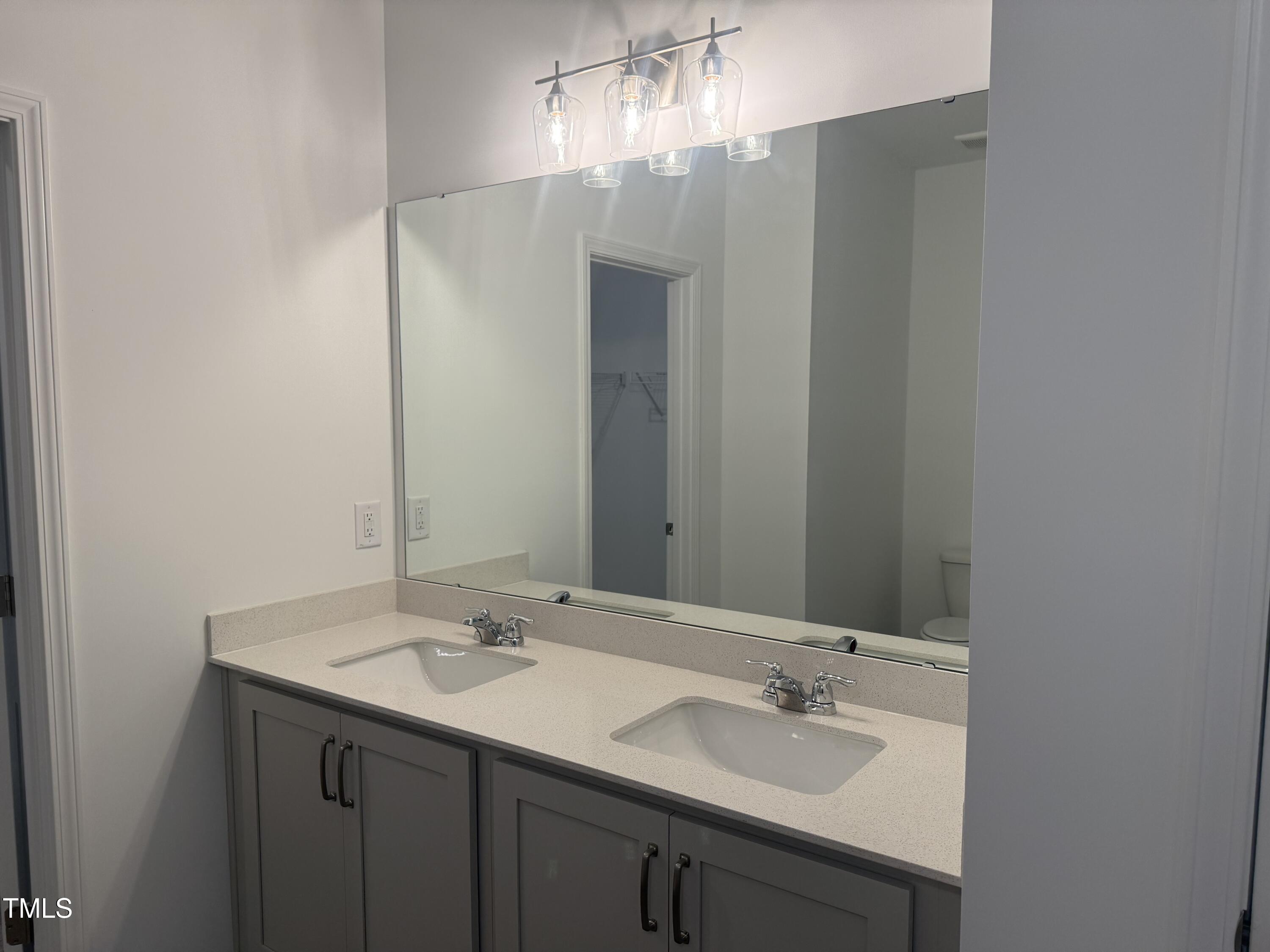 11185 Salers Loop Middlesex, NC 27557 - Photo 41 of 41 a bathroom with a sink and a mirror