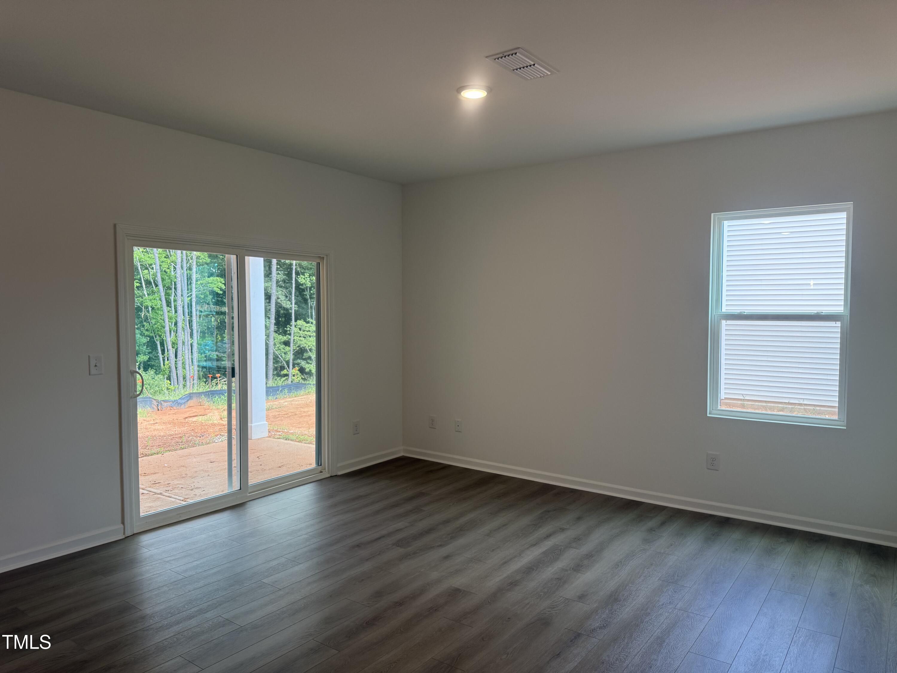 11185 Salers Loop Middlesex, NC 27557 - Photo 9 of 41 an empty room with wooden floor and windows