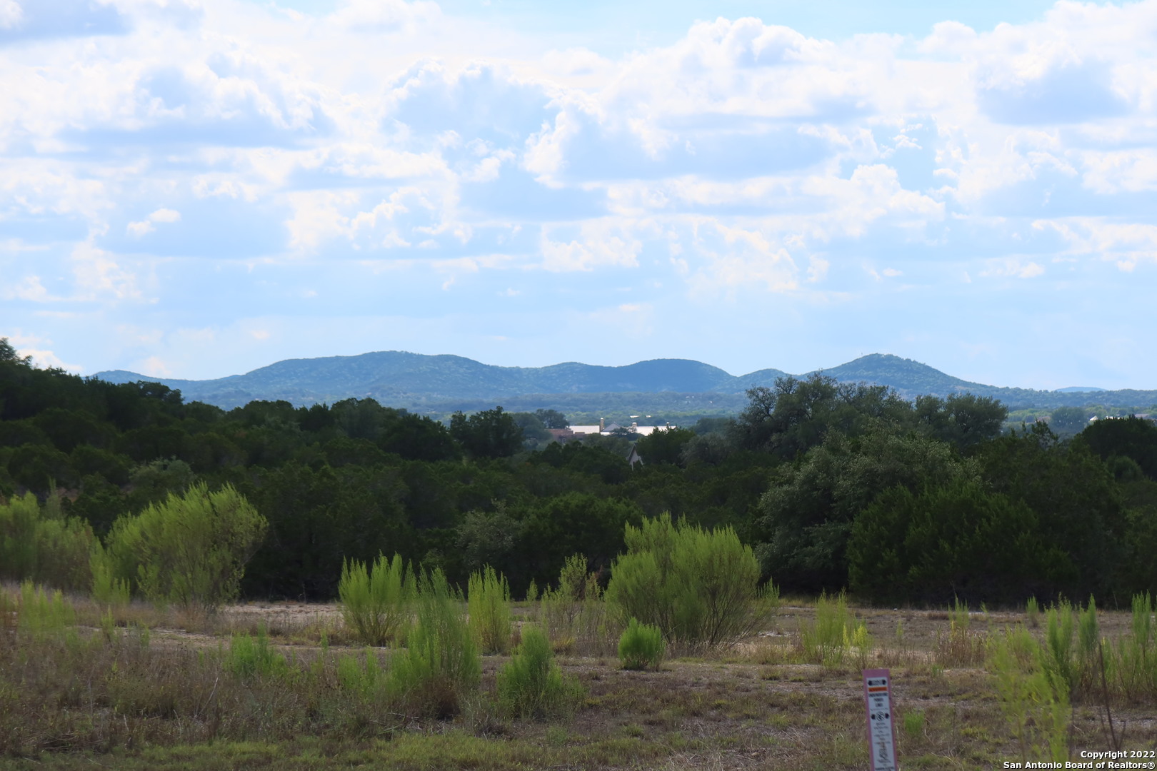 Tbd Little Sorrel Way Bandera, TX 78003 - Photo 5 of 12 a view of a town with mountains in the background