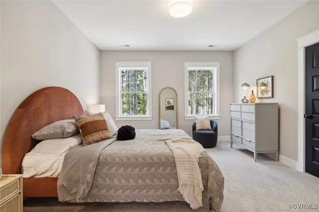 a bedroom with a bed couch and a window