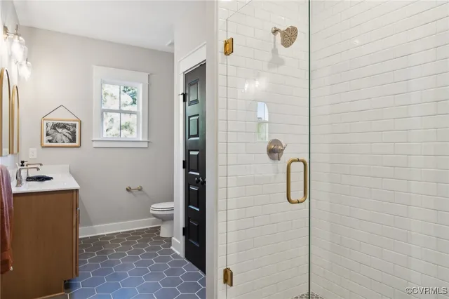 a bathroom with a sink toilet and a mirror