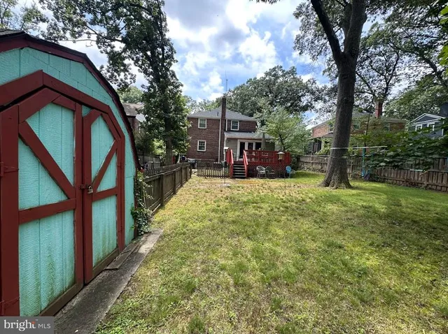 a view of swimming pool with a patio and a yard
