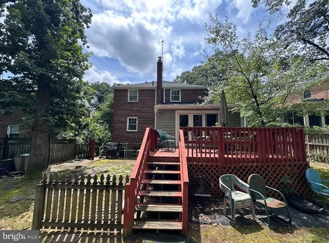 a front view of a house with a bench