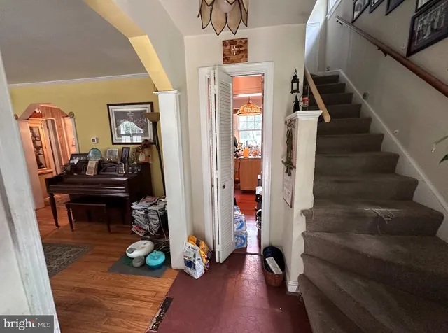 a view of entryway and hall with wooden floor